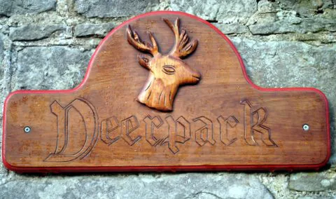 The carved Deerpark sign with a stag's head
