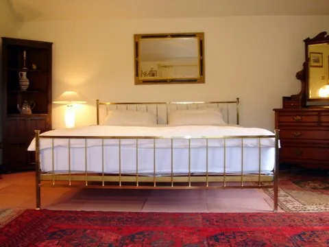 Bedroom with a brass king size bed